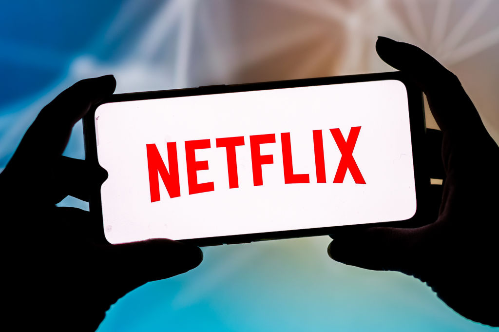 In this photo illustration a Netflix logo seen displayed on...