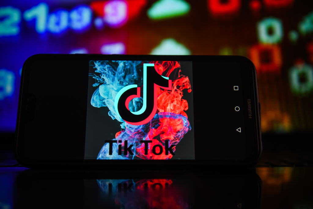 In this photo illustration a TikTok logo seen displayed on a...
