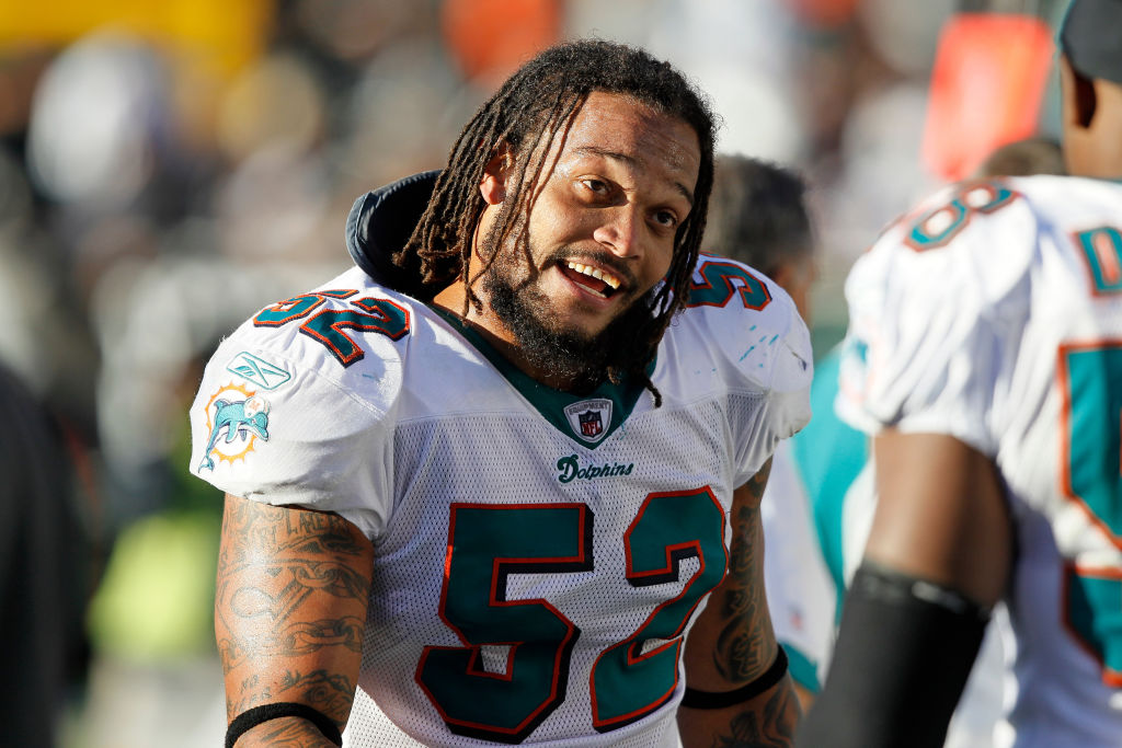 Channing Crowder smiles on the field during a Dolphins game.