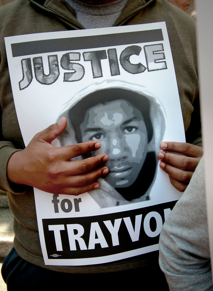 A poster of Trayvon Martin is displayed during a rally demanding justice for Martin in front of the Ronald Dellums Federal Building in downtown Oakland, Calif on Saturday July 20, 2013. The crowd joins a nationwide day of protests against last week's acqu