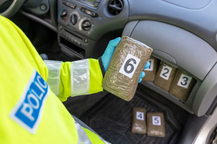 Police seize drug in stash spot of a vehicle during traffic stop stock photo