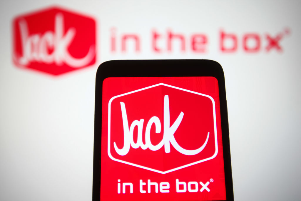 In this photo illustration, the Jack in the Box Inc. logo, a...