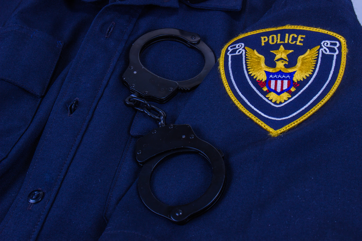 Law Enforcement Uniform With Generic Police Patch And Handcuffs