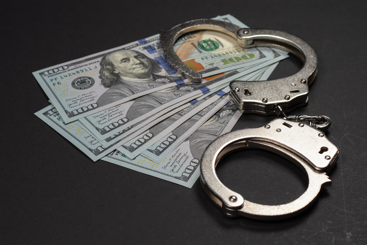 American dollars and handcuffs, Concept of ideas of corruption, dirty money or financial crimes