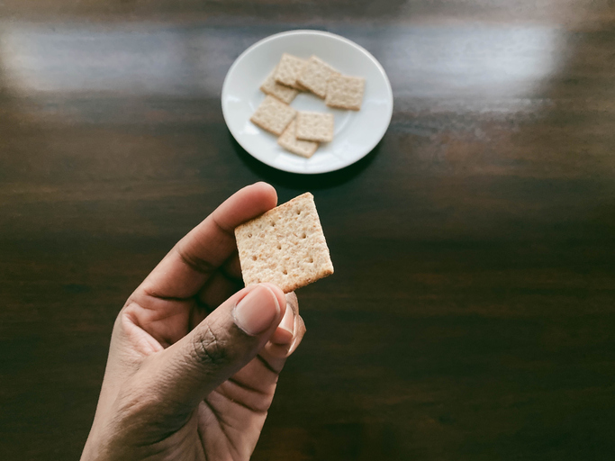 Close-Up of Woman’s Hand Holding Cracker