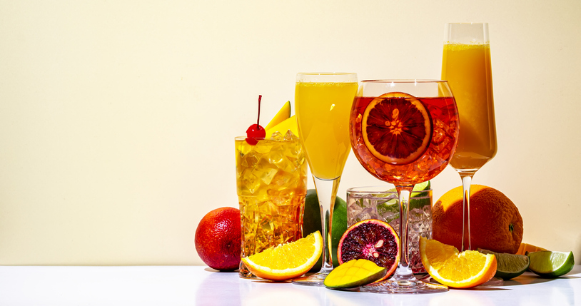 Summer citrus alcoholic cocktail drinks for cocktail party. Light beige background, hard light, shadow pattern