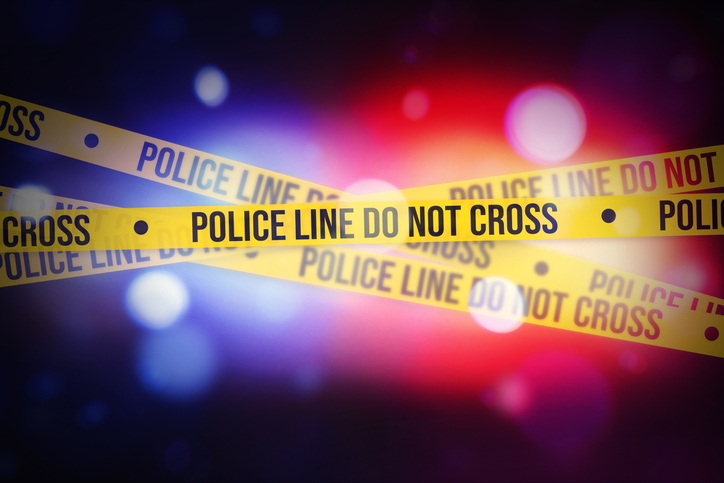 Glowing bokeh Police lights blur with Yellow tape showing typography do not cross, alert concept background. Police, legal, inquiry, warning concept