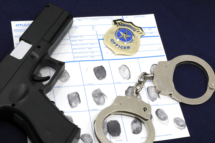 Firearm, handcuffs, police badge, and fingerprint evidence
