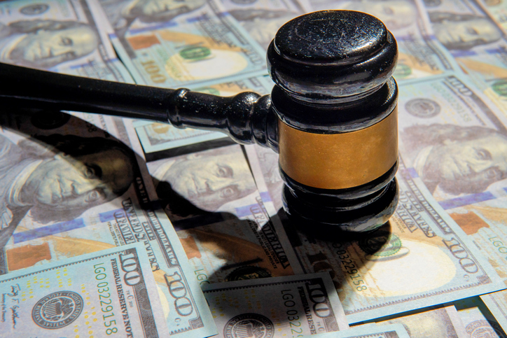 Closeup image of gavel and money.