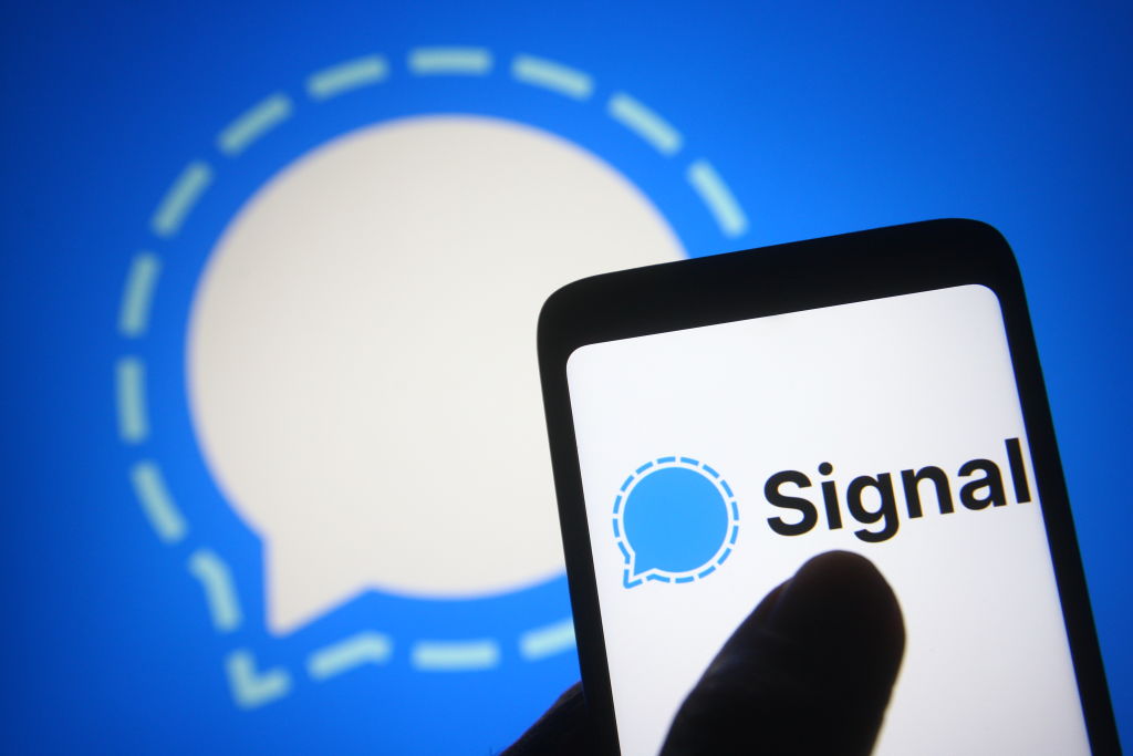 In this photo illustration a Signal logo is seen on a...