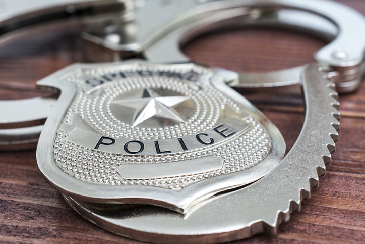 Police badge and handcuffs close-up
